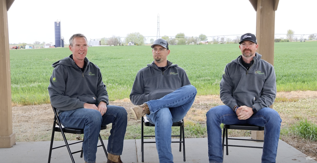 Three 21st Century Equipment employees sit together for the FarmCast episode.